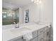 Bright bathroom with a double vanity, quartz countertops, and a view of the glass shower at 416 Clemson Tree Ln, Lake Wylie, SC 29710