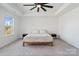 Cozy bedroom featuring a tray ceiling, neutral carpet, and an abundance of natural light at 416 Clemson Tree Ln, Lake Wylie, SC 29710