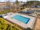Aerial view of a community pool, playground, and pavilion near a pond at 416 Clemson Tree Ln, Lake Wylie, SC 29710