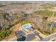 Overhead view of the community pool, parking, and pond among the wooded surrounding at 416 Clemson Tree Ln, Lake Wylie, SC 29710