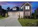 Charming two-story home featuring a two-car garage, landscaped yard, and welcoming front entrance at 416 Clemson Tree Ln, Lake Wylie, SC 29710