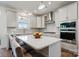 Bright kitchen features stainless steel appliances, quartz counters and an island with bar seating at 416 Clemson Tree Ln, Lake Wylie, SC 29710