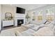 Bright living room features a fireplace, large windows and comfortable seating at 416 Clemson Tree Ln, Lake Wylie, SC 29710