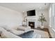 Cozy living room featuring a fireplace, plush sofa, and stylish decor at 416 Clemson Tree Ln, Lake Wylie, SC 29710