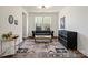Elegant living room with a tufted sofa, modern art, and a classic dresser at 416 Clemson Tree Ln, Lake Wylie, SC 29710
