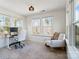 Bright office with neutral carpet, three windows, and a comfortable rocking chair at 416 Clemson Tree Ln, Lake Wylie, SC 29710