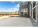 Concrete patio that leads into a large backyard with a trampoline and black metal fence at 416 Clemson Tree Ln, Lake Wylie, SC 29710