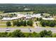 Aerial view of a large school campus with athletic fields and parking lots surrounded by trees at 416 Clemson Tree Ln, Lake Wylie, SC 29710