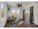 Bright sunroom with floor-to-ceiling windows, wicker chair and views of the outdoors at 416 Clemson Tree Ln, Lake Wylie, SC 29710