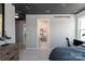 Bedroom featuring paper airplane ceiling art and neutral walls with a view into an adjacent bedroom at 4688 Glen Stripe Dr # Cal0069, Indian Trail, NC 28079