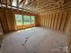Unfinished bedroom showcasing natural light, framing and ample space at 4688 Glen Stripe Dr # Cal0069, Indian Trail, NC 28079