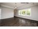 Large bedroom with tray ceiling, hardwood floors, and ample natural light from the windows at 4688 Glen Stripe Dr # Cal0069, Indian Trail, NC 28079