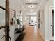 Hallway with hardwood floors, wall decor, and glimpses into the living areas at 4688 Glen Stripe Dr # Cal0069, Indian Trail, NC 28079