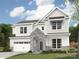 Elegant two-story home featuring stone accents, a two-car garage, and manicured front lawn at 4688 Glen Stripe Dr # Cal0069, Indian Trail, NC 28079