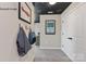 Hallway with gray carpet, custom ceiling art, and airport-themed wall art at 4688 Glen Stripe Dr # Cal0069, Indian Trail, NC 28079