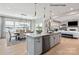 Bright, open-concept kitchen with island, dining area, and view of living room with fireplace at 4688 Glen Stripe Dr # Cal0069, Indian Trail, NC 28079
