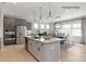 Modern kitchen with stainless steel appliances, light wood floors, and adjacent dining area at 4688 Glen Stripe Dr # Cal0069, Indian Trail, NC 28079