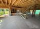 Unfinished living room with open floor plan, fireplace and sliding glass door to the backyard at 4688 Glen Stripe Dr # Cal0069, Indian Trail, NC 28079