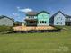 New home construction showing back exterior with spacious lawn and neighboring homes at 4688 Glen Stripe Dr # Cal0069, Indian Trail, NC 28079