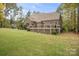Spacious backyard featuring a wooden deck and lush landscaping; perfect for outdoor entertaining at 472 Barber Loop, Mooresville, NC 28117