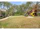Large backyard with lush lawn and custom wooden playset; perfect for outdoor fun and relaxation at 472 Barber Loop, Mooresville, NC 28117