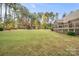 Expansive backyard with lush lawn and custom wooden playset; perfect for outdoor fun and relaxation at 472 Barber Loop, Mooresville, NC 28117