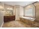 Bathroom featuring a soaking tub, glass enclosed shower, and a double vanity with granite countertop at 472 Barber Loop, Mooresville, NC 28117