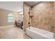 Bright bathroom with a bathtub and separate vanity area featuring granite countertops at 472 Barber Loop, Mooresville, NC 28117