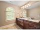Bright bathroom with double vanity, granite countertops, and a large arched window at 472 Barber Loop, Mooresville, NC 28117