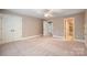Spacious bedroom with plush carpet and access to a walk-in closet and bathroom at 472 Barber Loop, Mooresville, NC 28117