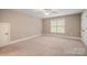 Neutral bedroom featuring plush carpet, a window for natural light, and a closet at 472 Barber Loop, Mooresville, NC 28117