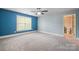 Spacious bedroom with soft carpet, ceiling fan, and attached bathroom at 472 Barber Loop, Mooresville, NC 28117