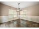 Bright dining room with hardwood floors, wainscoting, and three large windows with blinds at 472 Barber Loop, Mooresville, NC 28117