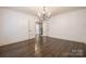 Open dining room with hardwood floors, a chandelier, and French doors leading to other rooms at 472 Barber Loop, Mooresville, NC 28117