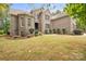 Charming brick home featuring manicured lawn, a fountain, and mature landscaping at 472 Barber Loop, Mooresville, NC 28117