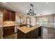 An open kitchen view with stainless appliances, granite countertops, wood cabinets, and a central island at 472 Barber Loop, Mooresville, NC 28117