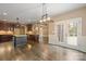 Open kitchen with island, stainless appliances, and dark wood cabinets next to the living area at 472 Barber Loop, Mooresville, NC 28117