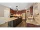 Open kitchen featuring an island with granite countertops, stainless appliances, and dark wood cabinets at 472 Barber Loop, Mooresville, NC 28117