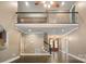 Open living room with hardwood floors, staircase, and a view of the second story balcony at 472 Barber Loop, Mooresville, NC 28117