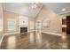 Spacious living room with a fireplace, hardwood floors, high ceilings, and views of the kitchen at 472 Barber Loop, Mooresville, NC 28117