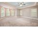 Spacious main bedroom with a tray ceiling, carpet flooring, and multiple windows for ample light at 472 Barber Loop, Mooresville, NC 28117
