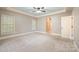 Large main bedroom with a tray ceiling, multiple windows, and access to an ensuite bathroom at 472 Barber Loop, Mooresville, NC 28117