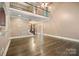 Open living room with hardwood floors, staircase, and view of the foyer at 472 Barber Loop, Mooresville, NC 28117