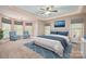 Serene primary bedroom with plush carpet, a cozy sitting area, and large windows at 472 Barber Loop, Mooresville, NC 28117