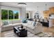 Bright living room with a large sectional sofa, open floor plan and expansive windows overlooking the backyard at 6005 Valehaven Pl # 0049, Charlotte, NC 28269