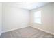 This well-lit bedroom features plush carpeting and a view of the outdoors at 620 Smith St # B, Mooresville, NC 28115