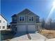 New two-story townhouse with gray siding, attached garage, and freshly poured concrete driveway at 620 Smith St # B, Mooresville, NC 28115