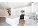 Modern kitchen with white cabinets, granite countertops, stainless steel appliances, and a large island at 620 Smith St # B, Mooresville, NC 28115