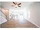 Sunlit living room featuring hardwood floors, a ceiling fan, and open concept layout to the kitchen at 620 Smith St # B, Mooresville, NC 28115