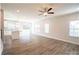 Open-concept living room with hardwood flooring, ceiling fan and an inviting transition into the kitchen at 620 Smith St # B, Mooresville, NC 28115